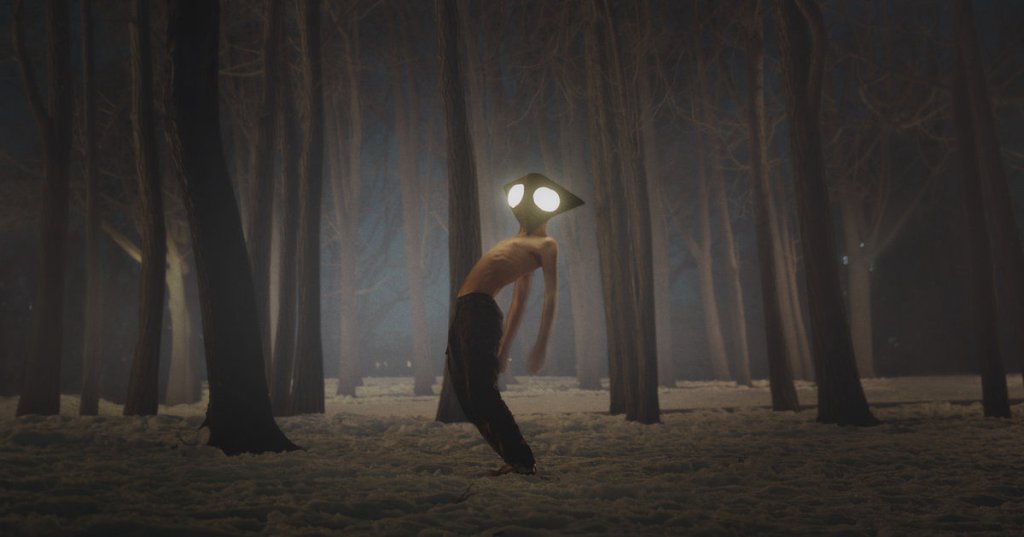 Shirtless boy wearing mask in forest