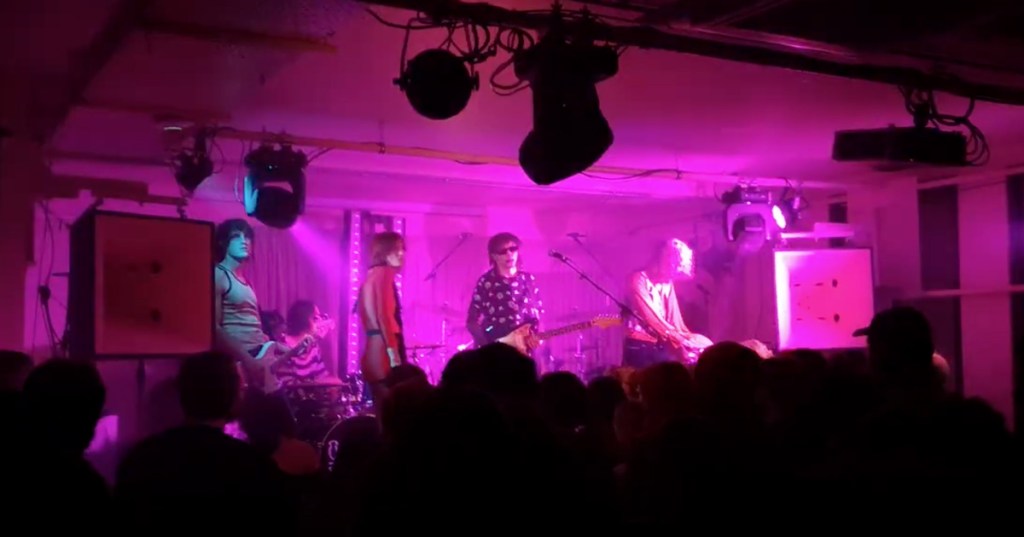 October and the Eyes on a pink illuminated stage